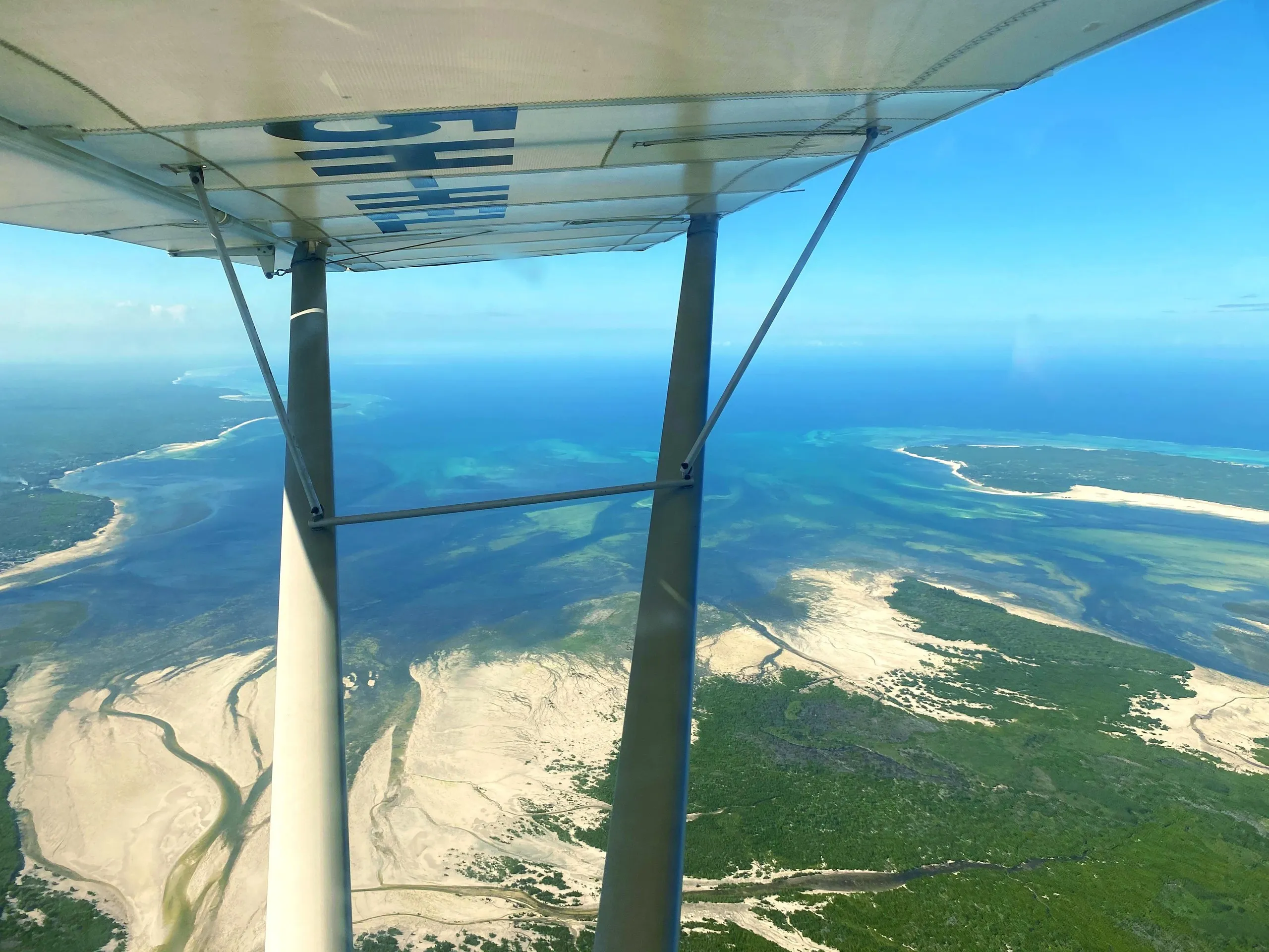 Light aircraft flying over the Zanzibar coast